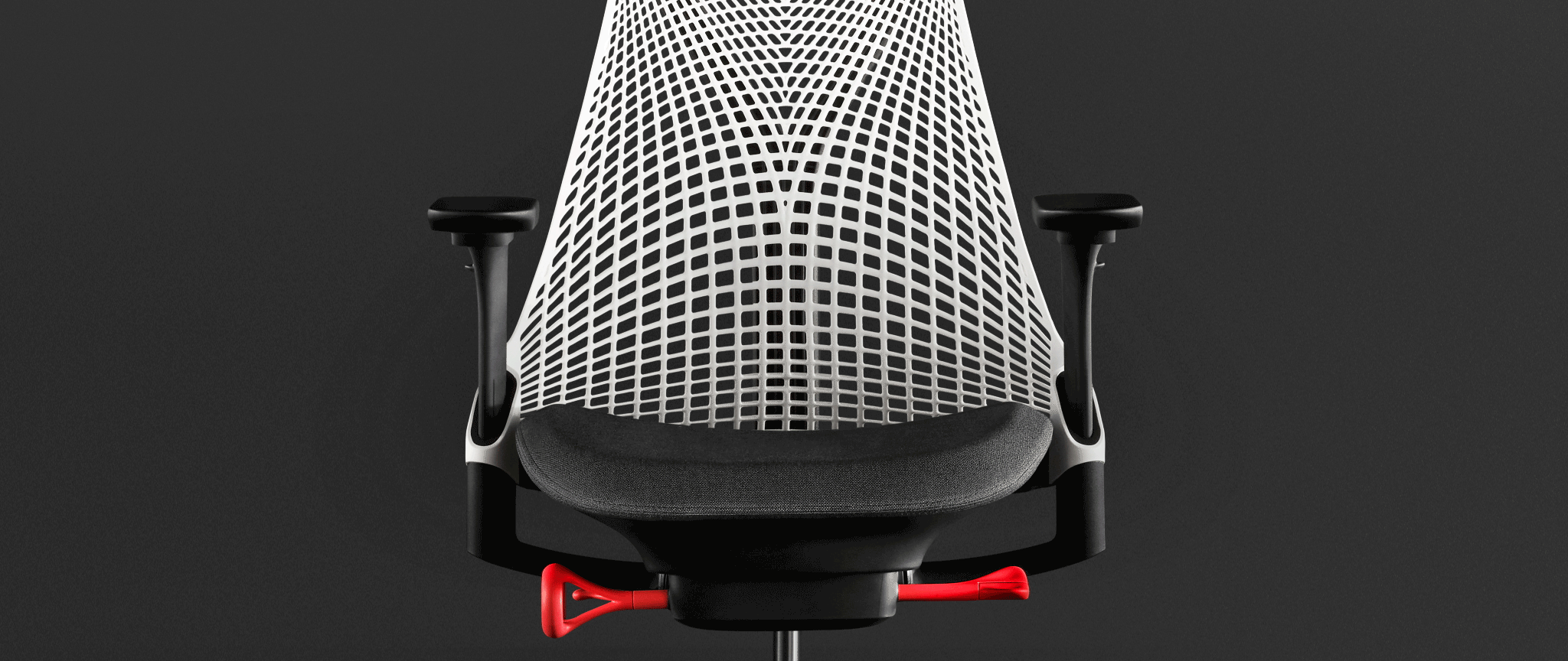 Rear view of a graphite Aeron office chair, showing back support and adjustable arms.