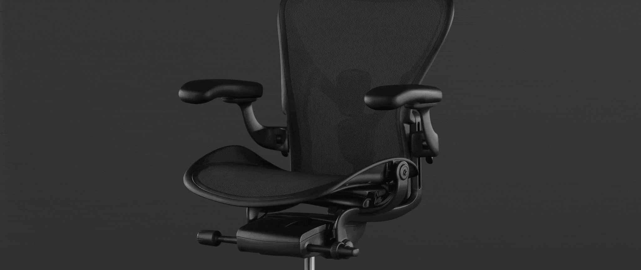 Rear view of a graphite Aeron office chair, showing back support and adjustable arms.