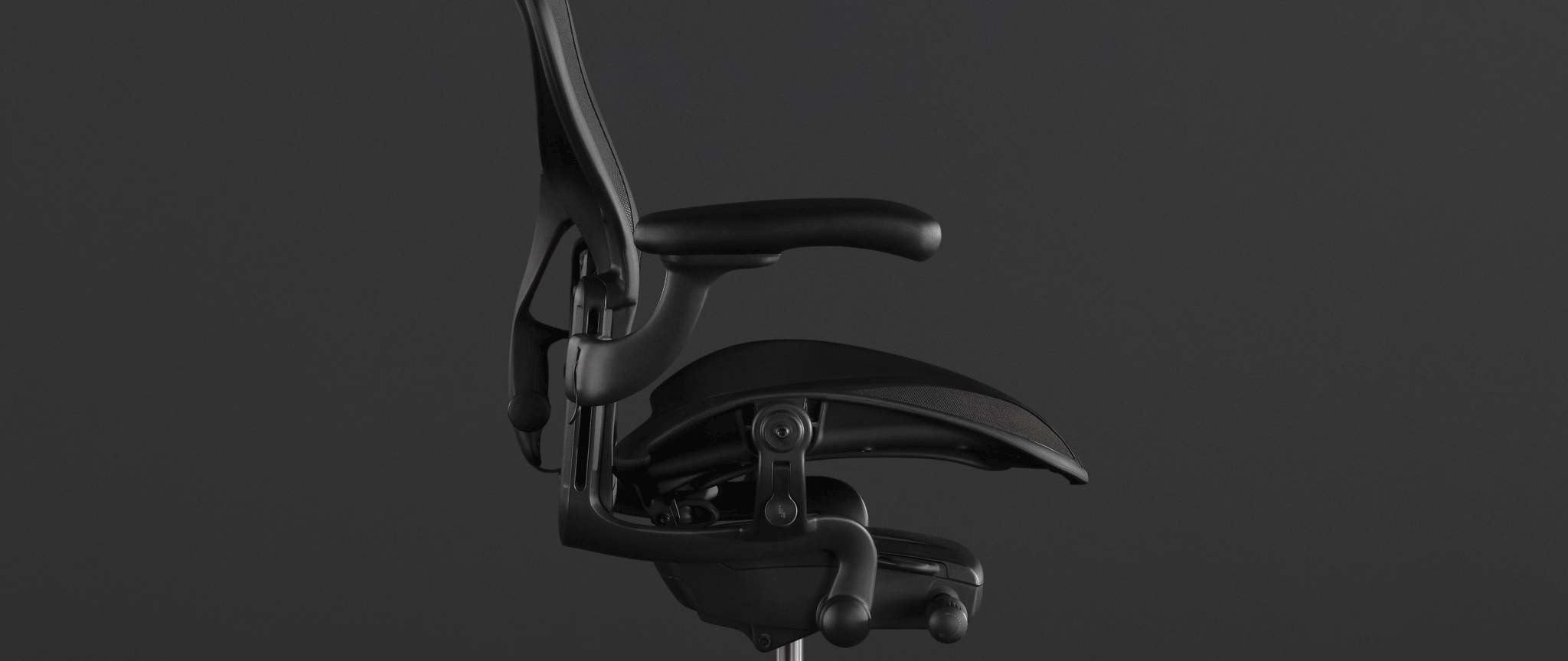 Close-up of the mesh pelicle suspension on the back of a graphite Aeron office chair
