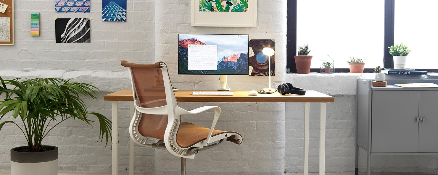 A graphite Aeron with a polished aluminium base in an home office setting