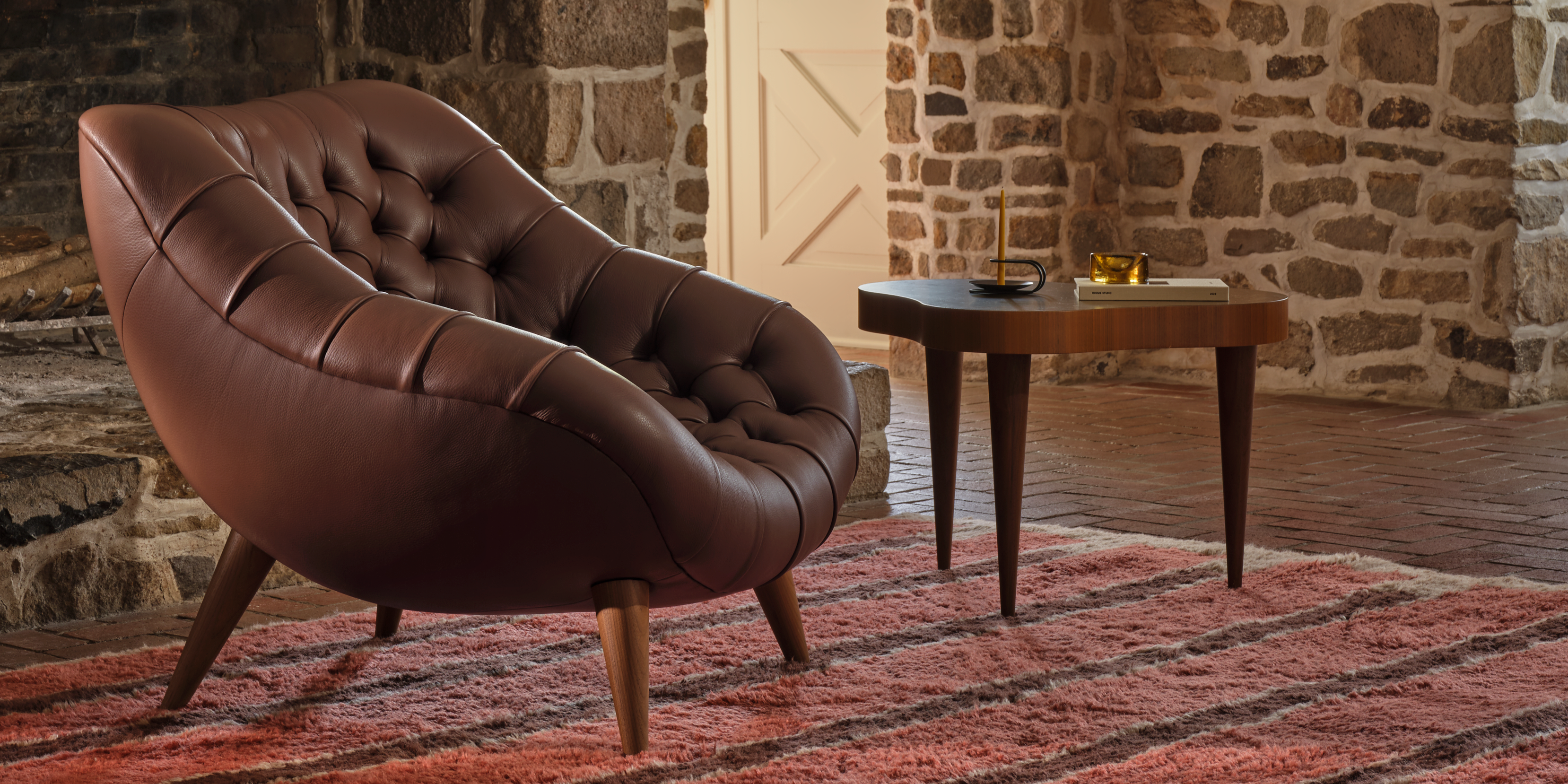 An AbakEnvironments Desk with a walnut top and polished legs, with a graphite Aeron Chair in a light home office setting and Folk Ladder Shelving.