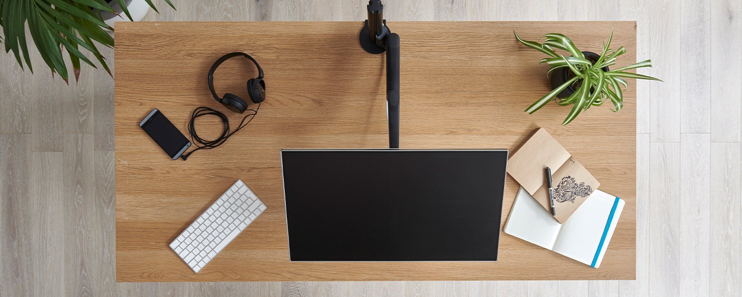 A graphite Aeron with a polished aluminium base in an home office setting