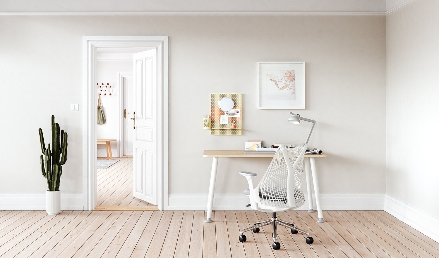 A white and grey Sayl chair alongside a Memo desk in a home office environment
